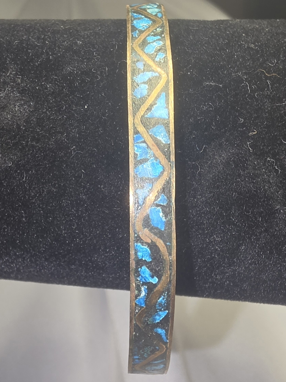 Vintage brass bangle bracelet featuring inlaid turquoise chips
